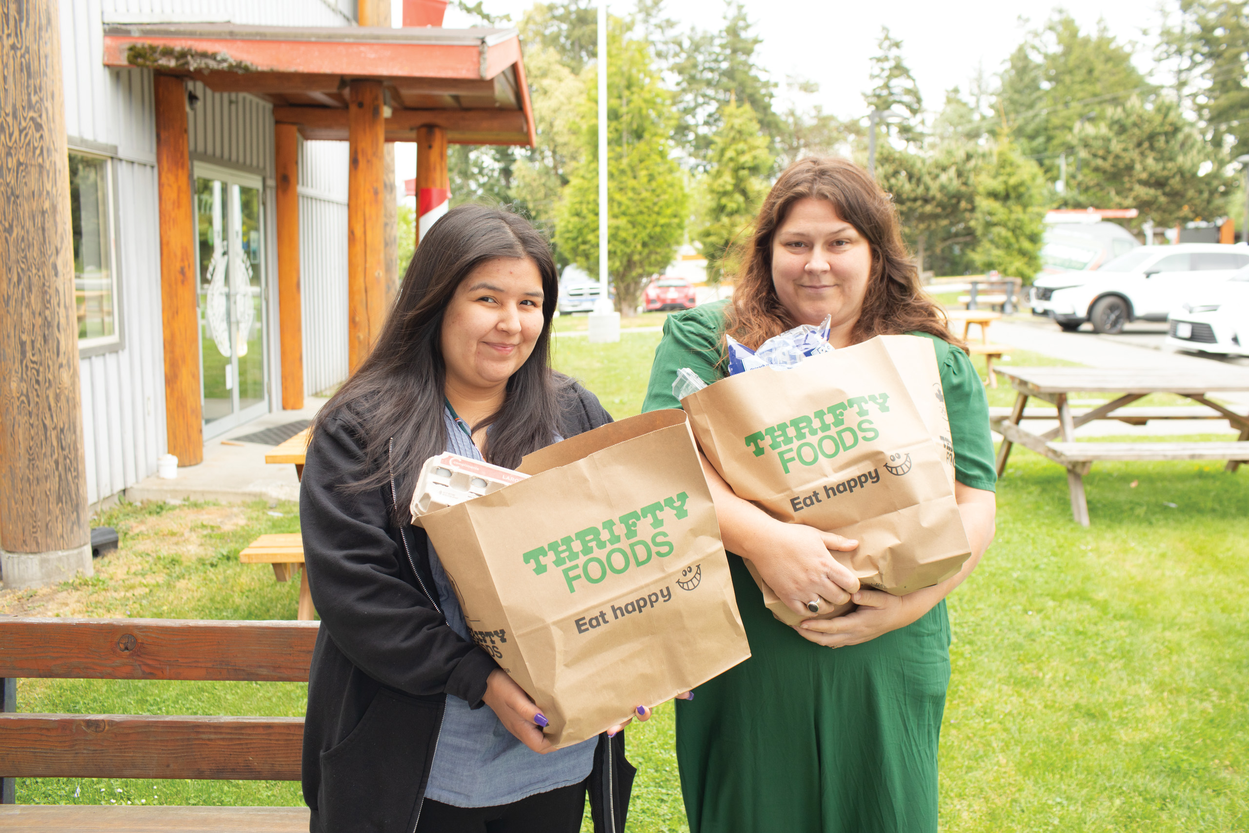 Women with Tsawout Head Start’s programming hold groceries.