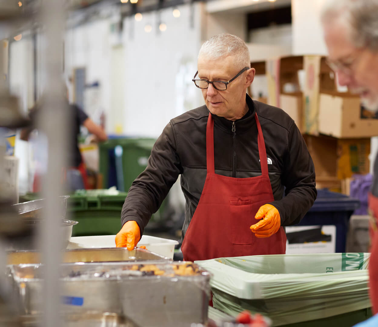 A volunteer prepares food at the Mustard Seed Food Security Distribution Centre.