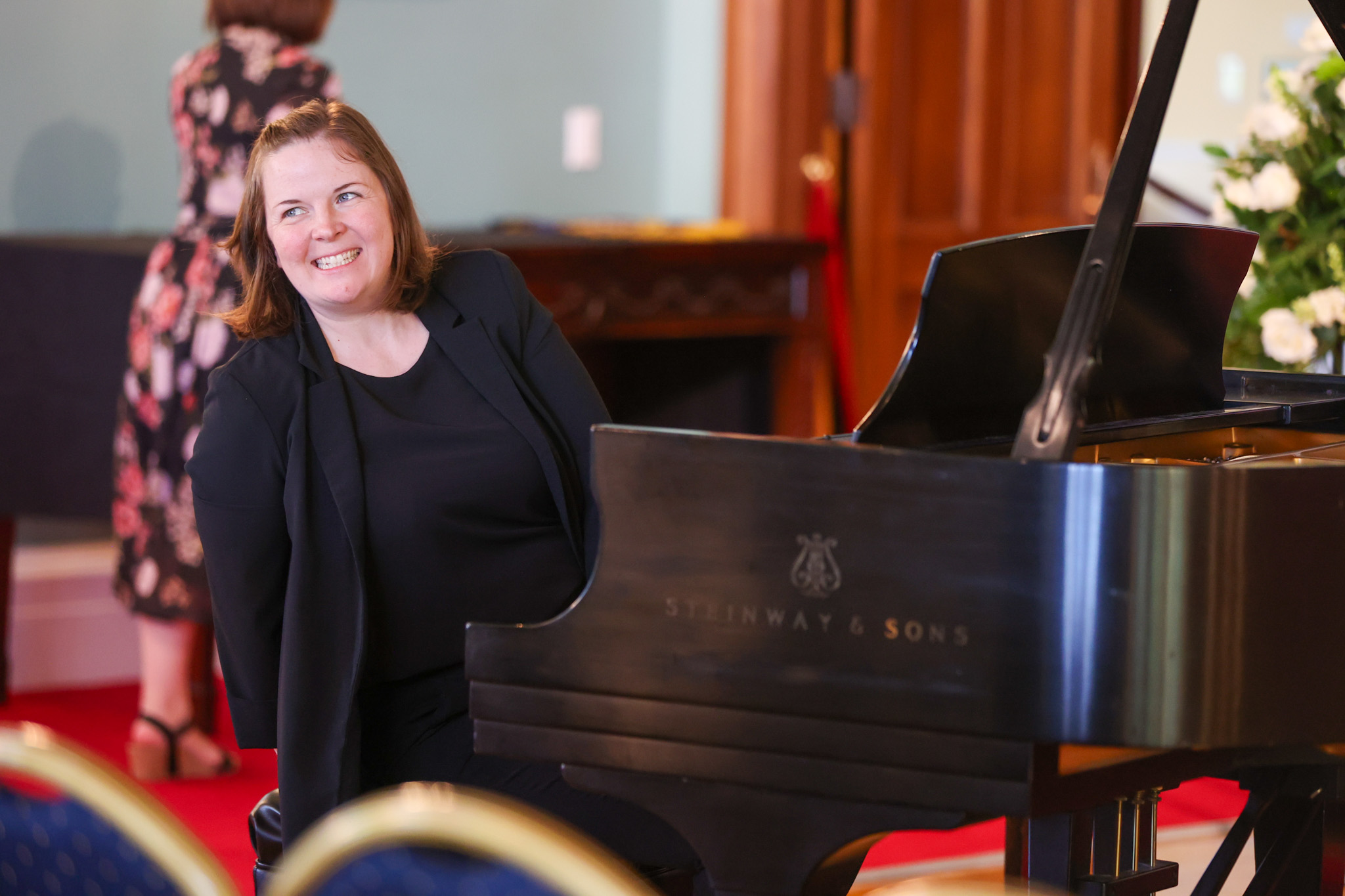 Kim Bartczak of Pacific Opera sitting at the piano. 