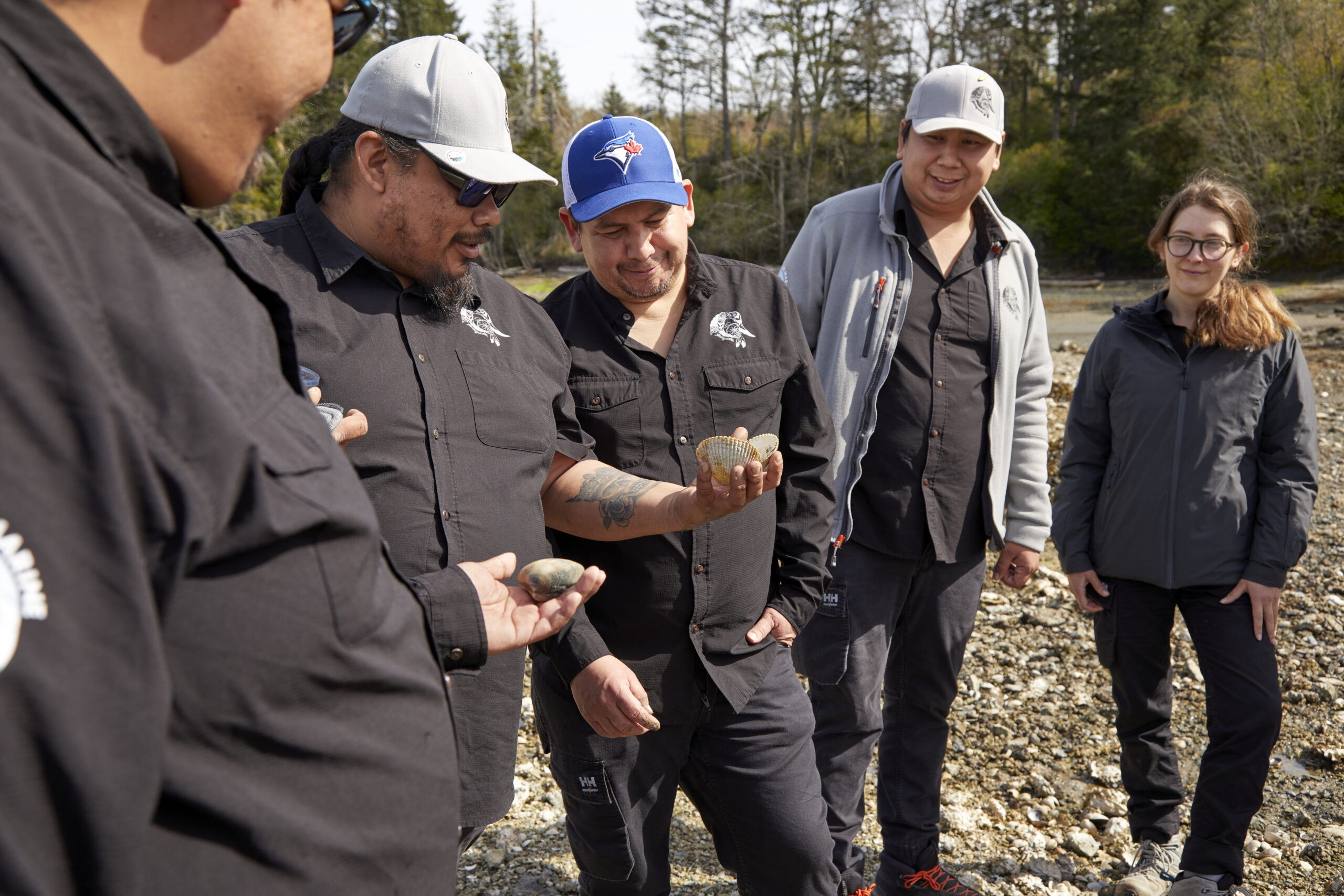 Pauquachin members examining harvested shellfish.