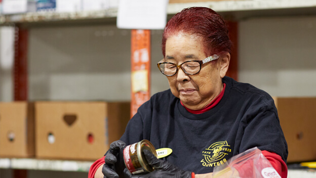 A woman sorts food donations at the Mustard Seed Food Security Distribution Centre.