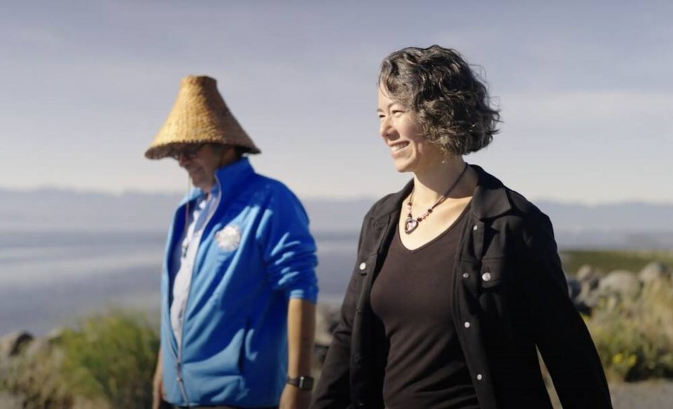 T'Sou-ke Nation chief Gordon Planes walks with Sooke mayor Maja Tait on the beach near Siaosun.