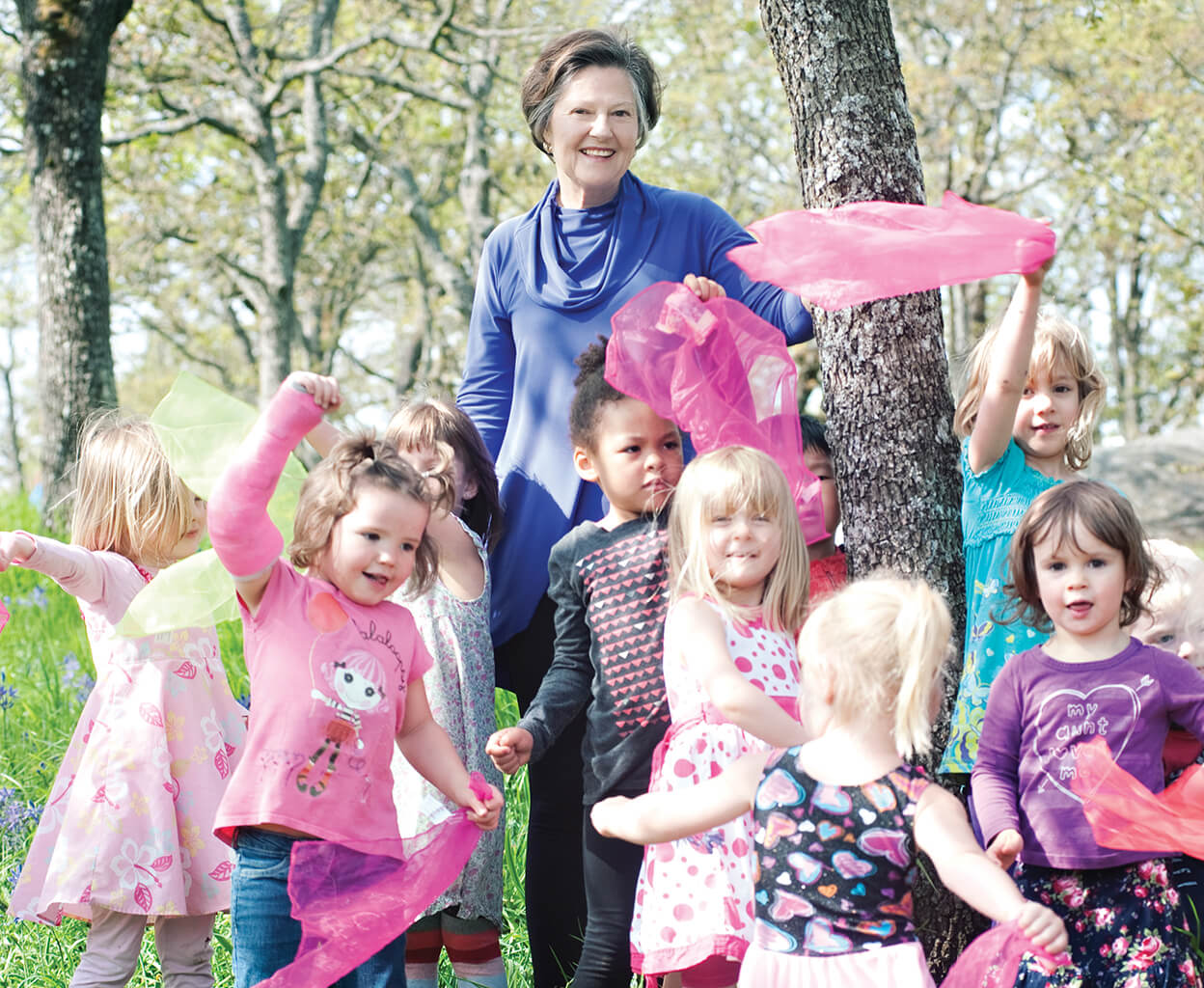 Sandra Richardson with a group of children playing outside